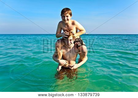 Brothers   Enjoy The Clear Warm Water And Play Pickaback