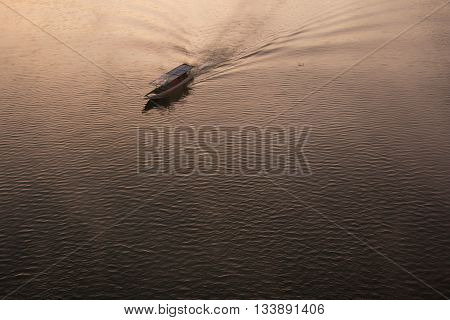 a long boat with a small motor driving a propeller at the end of a long shaft
