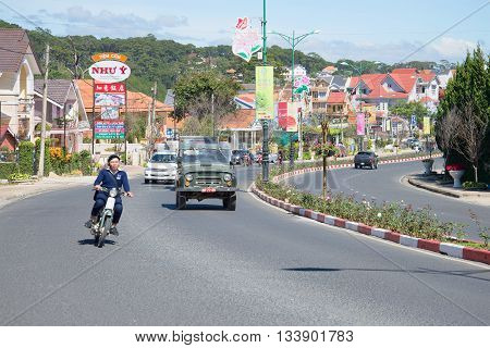 DALAT, VIETNAM - DECEMBER 28, 2015:  Sunny day on the streets of Da Lat. People go about their business on the street
