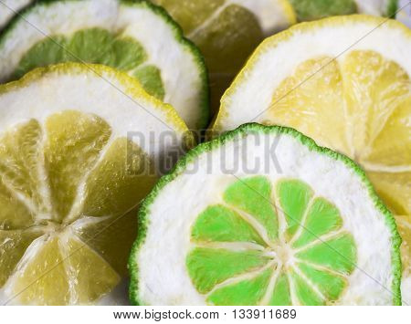 lemons and limes on white background. Green and yellow.