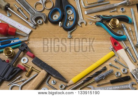 Happy fathers day: tools symbol heart on wooden background. Construction concept