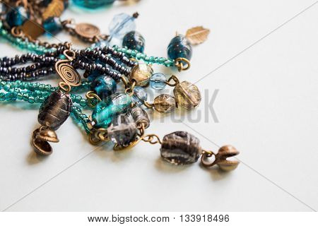 African traditional ethnic beards jewelry necklace in blue turquoise tint on white background. Modern art accessories.