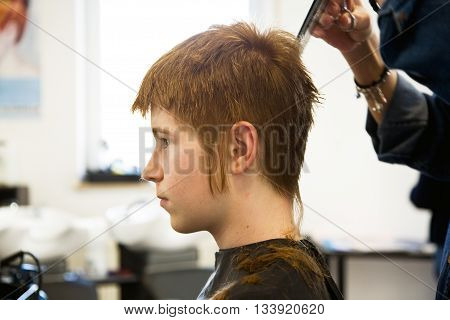 Smiling Young Boy With Red Hair At The Hairdresser