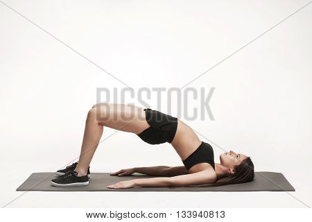 Portrait of young attractive woman doing exercises. Brunette with fit body on yoga mat. Healthy lifestyle and sports concept. Series of exercise poses.
