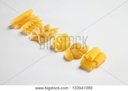 various dry pasta on the white background
