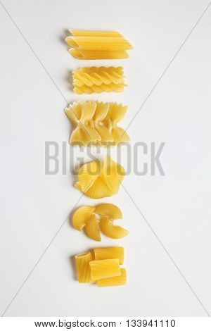 various dry pasta on the white background
