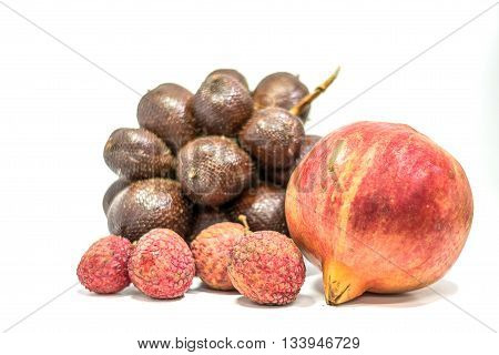 Fresh lychees pomegranate fruit and Indonesi Salak on white background