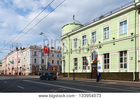 GOMEL BELARUS - MAY 1 2016: Unidentified people walk down street Sovetskaya near branch of National Bank of Belarus (former Russian-Asian Bank) Gomel Belarus