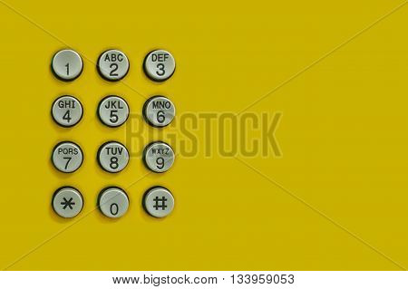 Numeric keypad of phone on the yellow background for the design Technology backdrop.