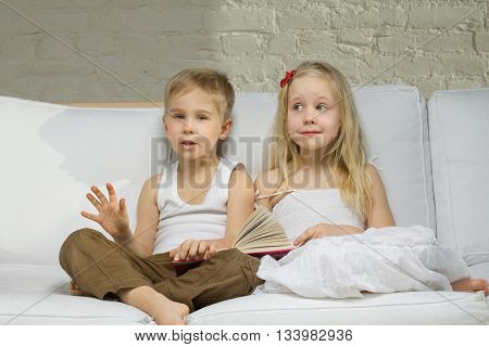 two Smiling children twings read a story