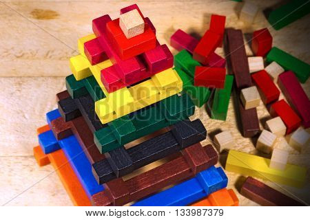 Close up of a pyramid made with colorful pieces of wood. Toy for learn the creativity and dexterity