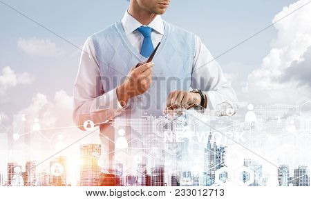 Double Exposure Of Confident And Young Businessman In Smart-casual Wear Smoking Pipe And Modern City