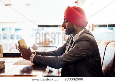 Indian Businessman In A Cafe Taking A Coffee