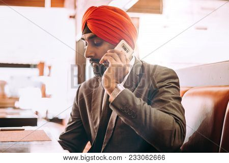 Indian Businessman In A Cafe Taking A Coffee