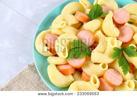 Pasta Cavatappi Or Cellentani With Sausages On A Gray Table