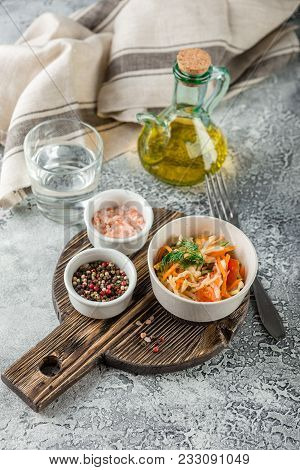 Cabbage Salad With Carrots, Tomatoes And Cucumbers In A Small Pial On A Light Table. Traditional Col