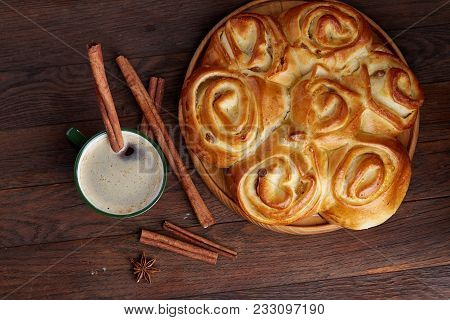 Homemade Rose Bread With Raisins On Wooden Tray, Cup Of Creamy Coffee, Anise And Cinnamon Over Vinta