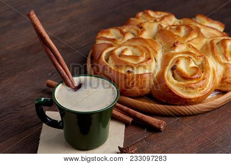 Homemade Rose Bread With Raisins On Wooden Tray, Cup Of Creamy Coffee, Anise And Cinnamon Over Vinta
