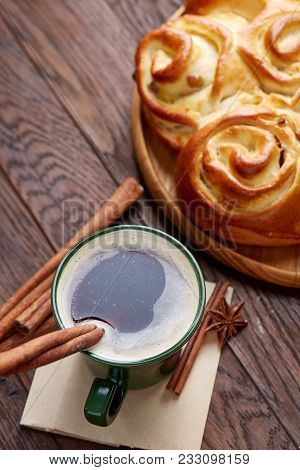 Homemade Rose Bread With Raisins On Wooden Tray, Cup Of Creamy Coffee, Anise And Cinnamon Over Vinta