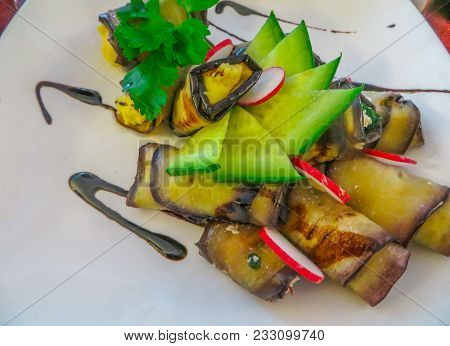 Slices Of Fried Eggplant Stuffed With Philadelphia Cheese With Garlic And Herbs On A Plate