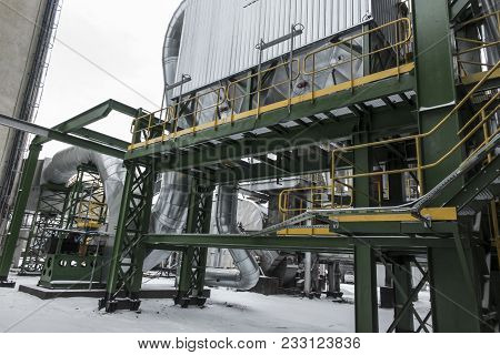 High, Concrete Industrial Chimney And Dust Collector On A Foggy Winter Day
