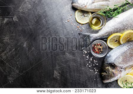 Fresh Uncooked Dorado Or Sea Bream Fish With Lemon Slices, Spices And Herbs. Mediterranean Cuisine. 