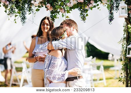 Eclectic Wedding Couple Under The Flower Arch. Rustic And Hippie Style Pair