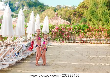 Happy Little Girls On The Beach