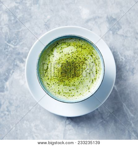 Cup of Matcha Latte on stone background; seen from above