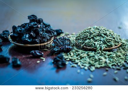 Raw Dried Fennel With Black Raisin A Ayurvedic Treatment To Cure Dehydration On Wooden Surface In Da