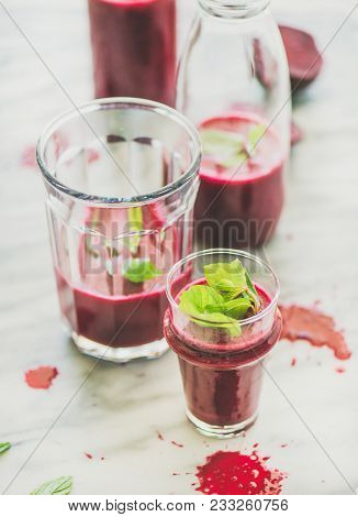 Fresh Morning Beetroot Smoothie Or Juice In Glass And Bottle With Mint Leaves Over Grey Marble Backg