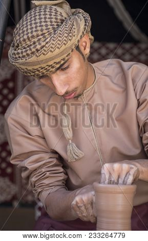 Nizwa, Oman, March 24th, 2018: Omani Man Making A Piece Of Pottery