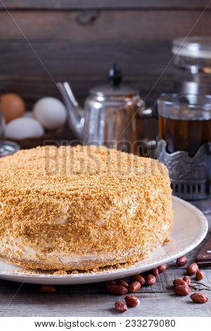 Homemade Biscuit Cake With Sour Cream On A Wooden Table