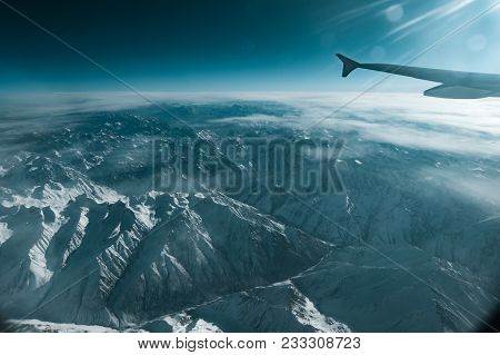 Photo Of Winter Mountain View From Plane Window. Shot In The Kasakhstan Tanshan Mountains