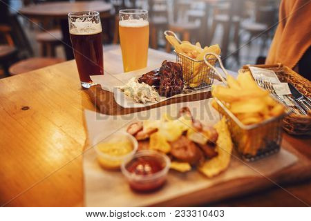 Delicious Smoked Sausage With Chips, French Fries And Steak With Sauce On Wooden  Board. Street Fast