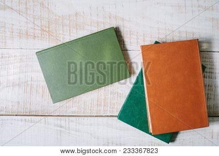 Books Lie On A Wooden Table. Top View. Layflat