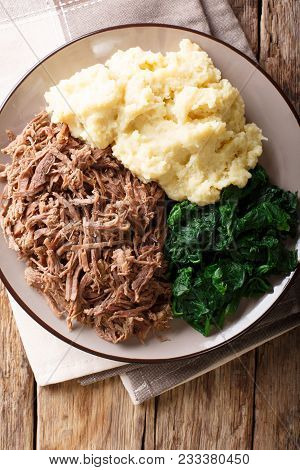 South African Food: - Seswaa Shredded Beef With Sadza Porridge And Spinach Close-up On A Plate. Vert
