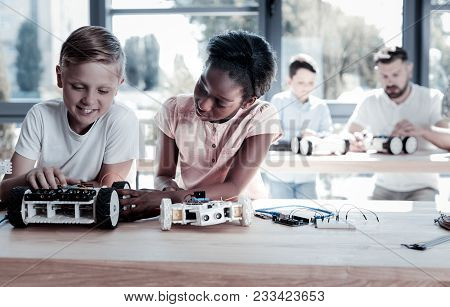 Always Work As A Team. Smart Preteen Children Sitting Next To Each Other And Focusing Their Attentio