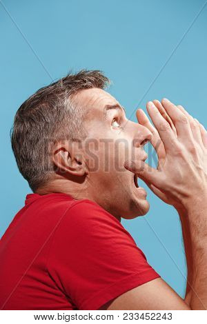 Portrait Of The Scared Man On Blue