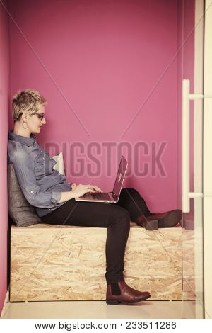 young woman in crative box working on laptop computer, startup business modern office room  interior