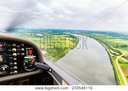 View from a flying sport plane over beautiful river landscape