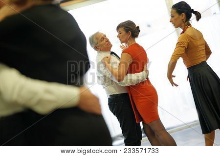 Group of senior people in dancing class with dance teacher
