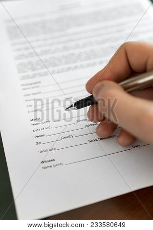Man Is Signing Model Release For Microstock.