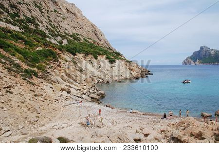MAJORCA, SPAIN - SEPTEMBER 3, 2017: People enjoy the secluded beach at Cala de Boquer on the Spanish island of Majorca. The beach lies at the end of the Boquer valley in the Tramuntana mountains.