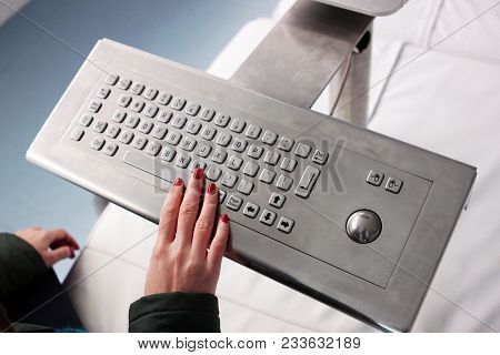Female Hand Is Giving Soft Touch Of Metallic, Shiny Keyboard. The Person Is Looking For Information 