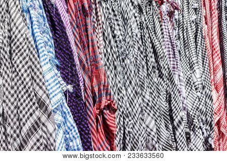Traditional Keffiyeh Or Kefia Hanging On Hangers On Bazaar In Egypt.