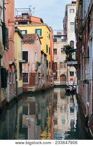 Traitional Venice Canal With Reflection Of Houses, Italy
