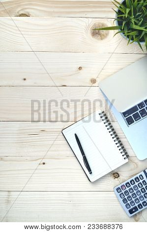 Pine Wood Of Desk Table With Workspace And Empty Blank Notebook,computer Laptop,calculator,pen,flowe