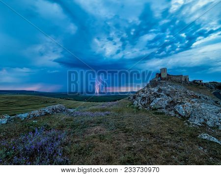 Thunderbolts,lightning On A Cloudy Evening Blue Sky Over Old Enisala Stronghold,citadel, Dobrogea, R
