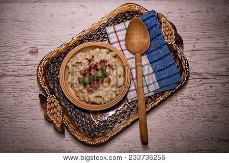 Slovak Traditional Potato Gnocchi With Sheep Cheese On A Wooden Table Laid On A Table